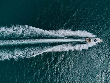 motorboat cruising on a calm lake during summer, used for relaxing sleep sounds